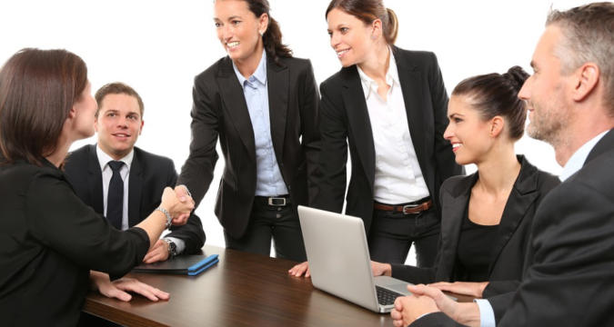 a group of people having an agreement in the office
